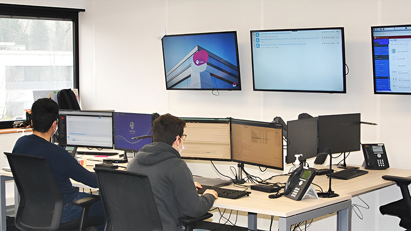 Two people from the back working at their desk